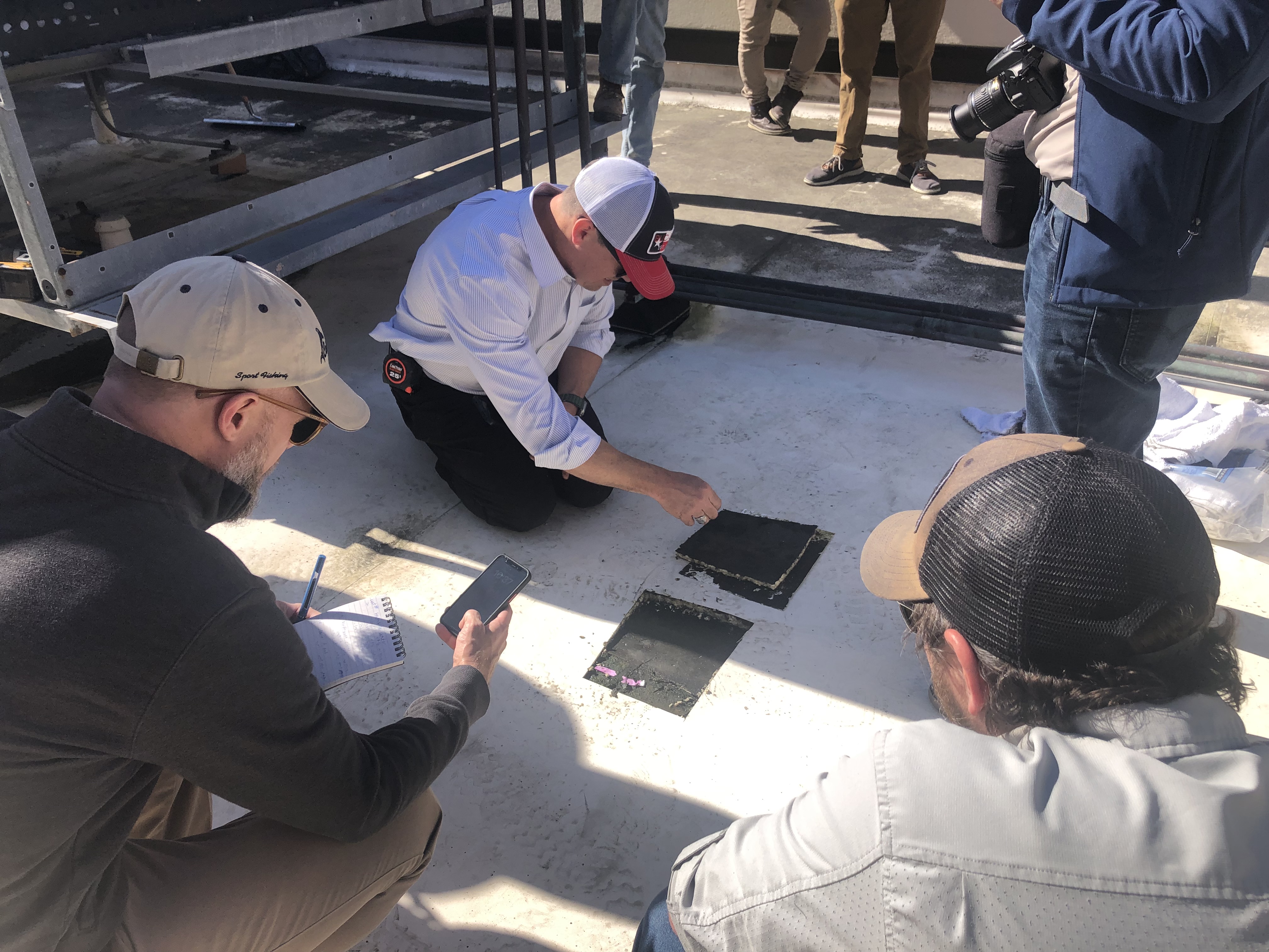 CSI engineers evaluating commercial roof condition and collecting core samples in Florida