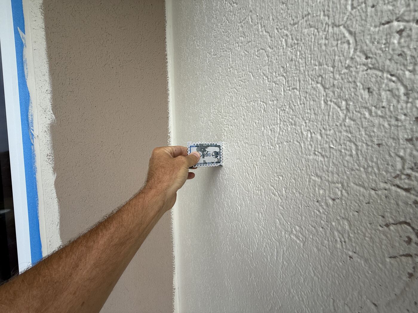 New stucco finish being checked during the exterior restoration at Ocean Place Condominiums