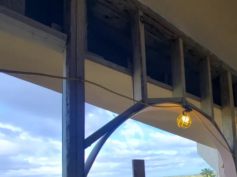 Exposed wood framing around a breezeway arch before finishes.