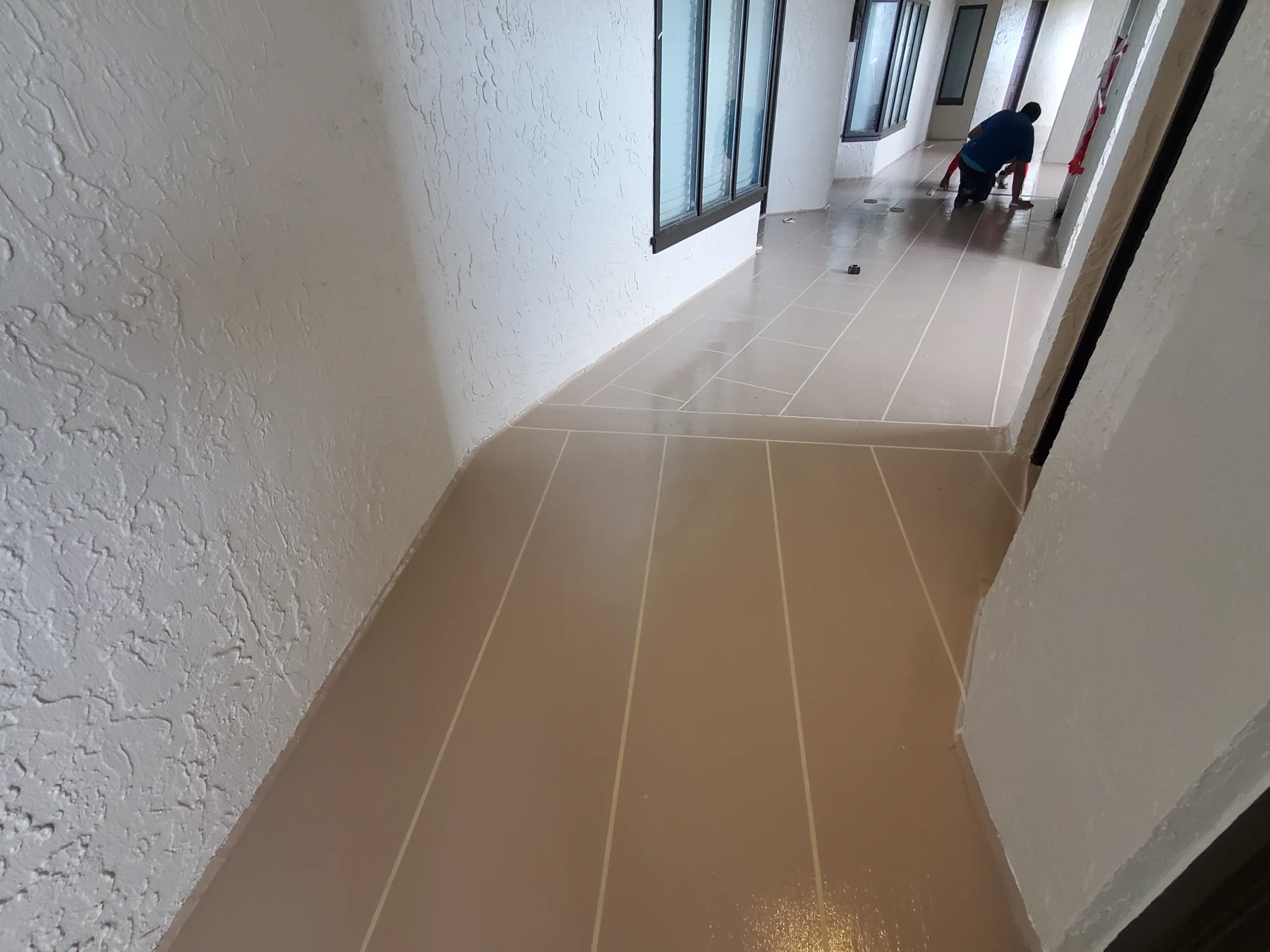 Tape marking decorative grout lines in the Sea Dunes waterproofing finish