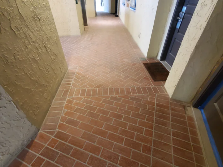 The red tile and its dense joint pattern before this walkway area was resurfaced.