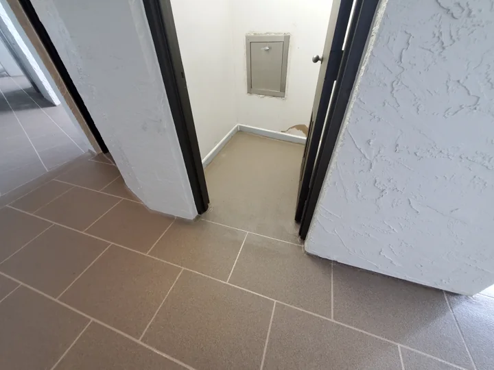 The new floor pattern and wall-base detail at a common-area doorway.