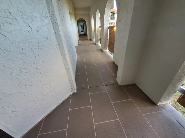 A longer view of the installed floor finish through the repeating breezeway openings.