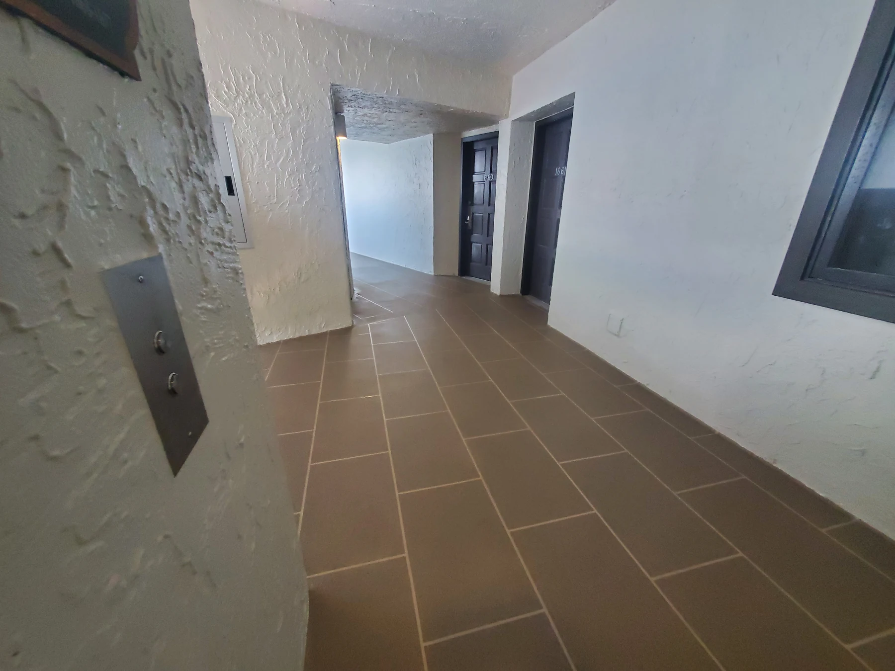 Sea Dunes walkway with its new taupe decorative waterproofing finish and white walls