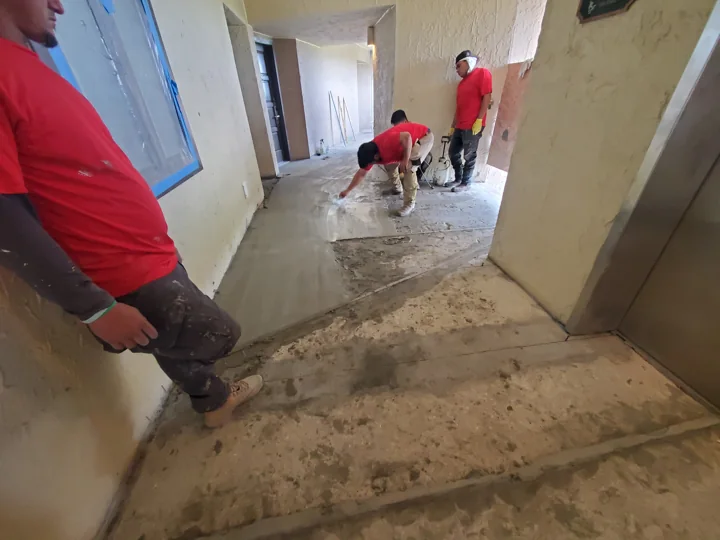 The crew works on the exposed walkway surface ahead of the finish system.