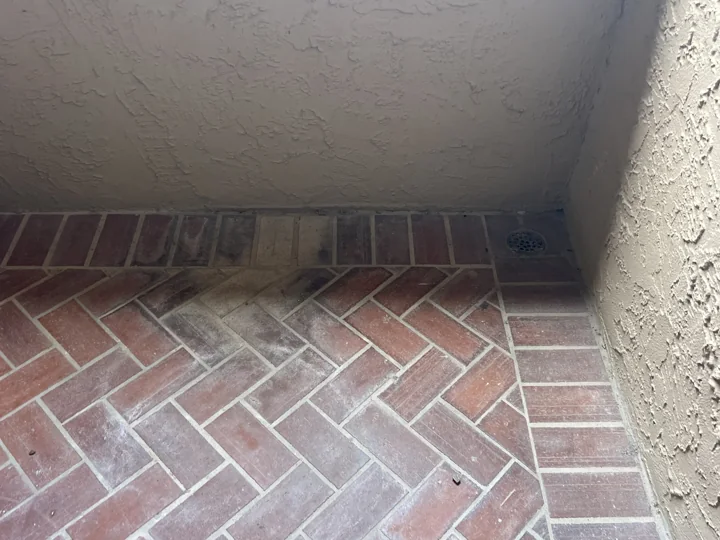 Discoloration and worn finishes where the tile meets the wall.