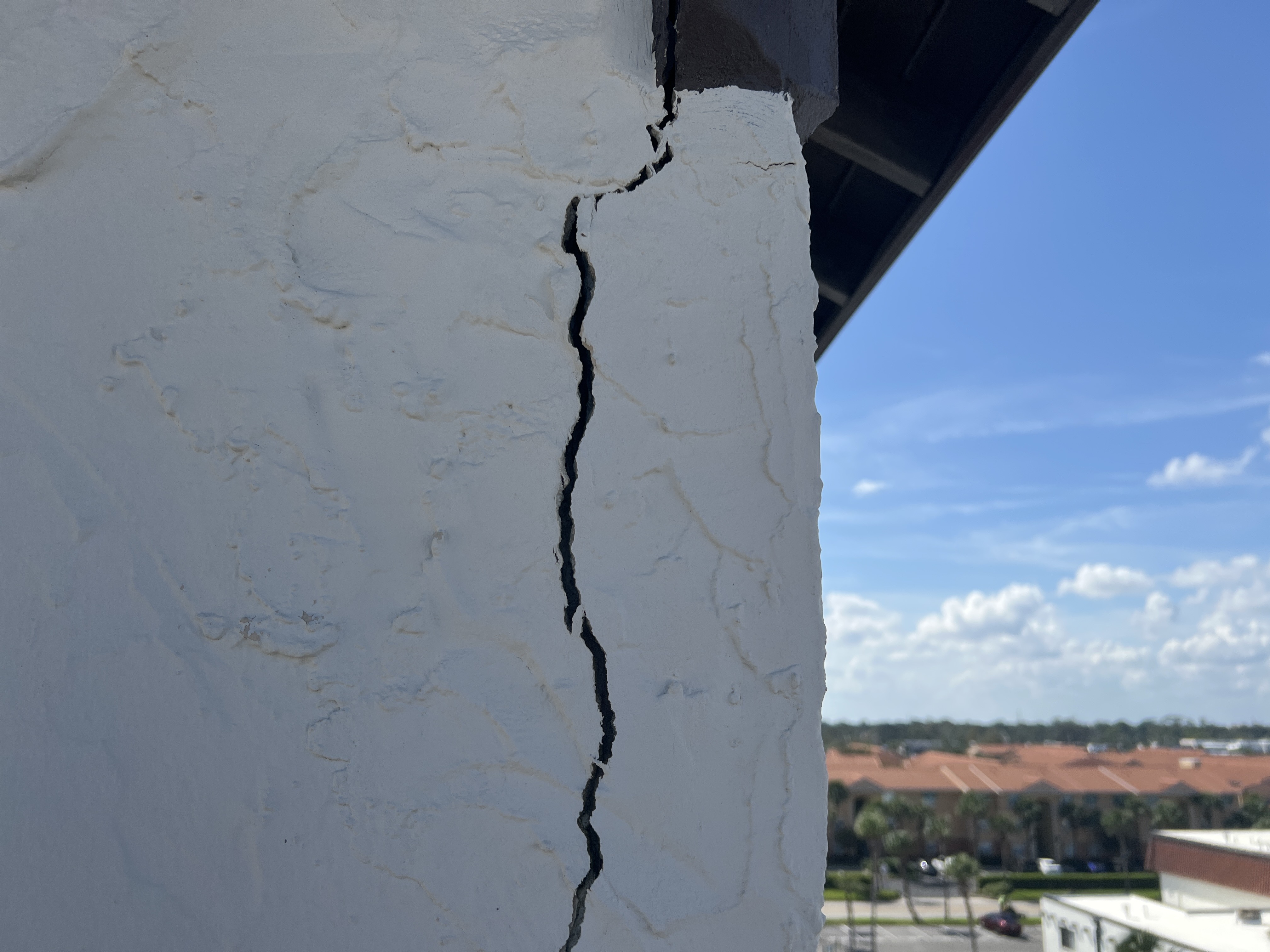 Significant stucco facade crack documented during structural inspection in Florida