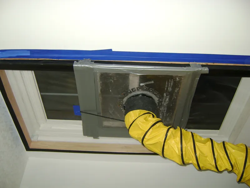 Plastic pressure chamber sealed over the interior side of a window with a yellow air hose attached