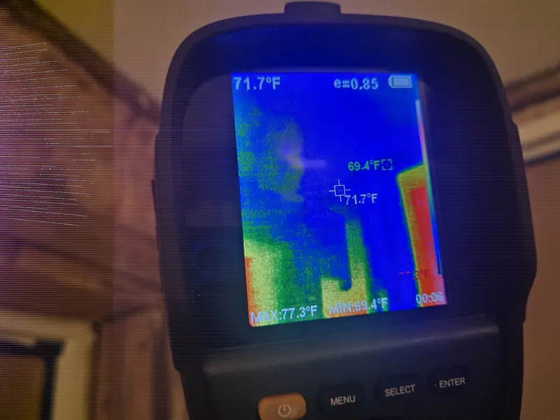 Thermal imaging camera screen showing cooler areas on an interior wall during a water test